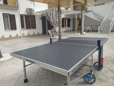a ping pong table in the middle of a courtyard at Apartment Wohnung 8 by Interhome in Balestrate