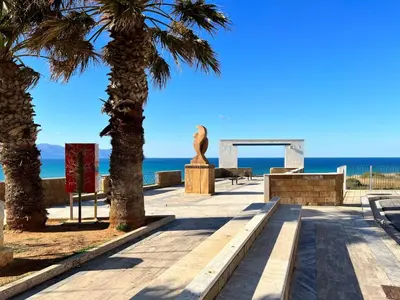 a path with palm trees and the ocean in the background at Apartment Wohnung 8 by Interhome in Balestrate