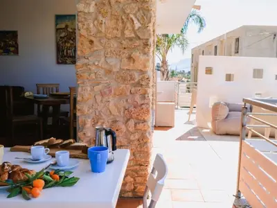 a table with food on top of a stone wall at Apartment Wohnung GIallo mit Schwimmbad und Meerblick by Interhome in Balestrate