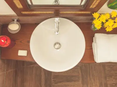 a white sink in a bathroom with flowers and towels at Apartment Wohnung GIallo mit Schwimmbad und Meerblick by Interhome in Balestrate