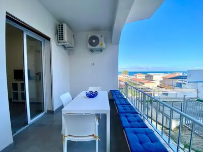 a white table and chairs on a balcony at Apartment Casa La Mamà- Strand 150 m entfernt by Interhome in Alcamo