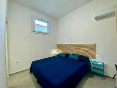 a bedroom with a blue bed and a window at Apartment Casa La Mamà- Strand 150 m entfernt by Interhome in Alcamo