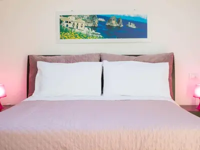 a bedroom with a bed with two white pillows at Holiday Home Villa in Sizilien am Meer mit beheiztem Pool by Interhome in Alcamo Marina