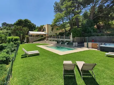 a backyard with a swimming pool and chairs and a lawn at Holiday Home Villa Tommaso Maruggi Jacuzzi und privater Pool by Interhome in Alcamo