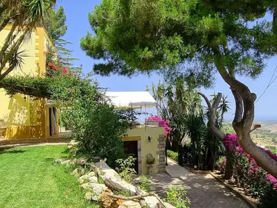 a house with trees and flowers in a yard at Holiday Home Villa Tommaso Maruggi Jacuzzi und privater Pool by Interhome in Alcamo