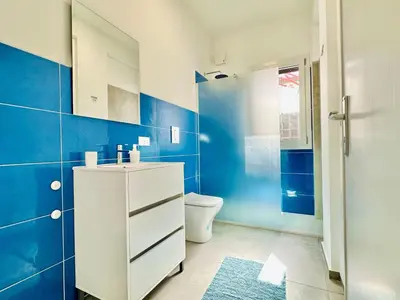 a blue bathroom with a toilet and a sink at Apartment Sea Life Giulia- 200 m vom Strand entfernt by Interhome in Alcamo Marina