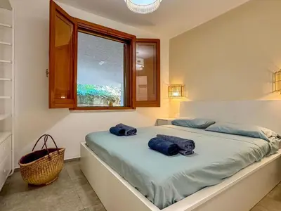 a bedroom with two towels on a bed with a window at Apartment Villa Sao- Scopello- Punta Pispisa by Interhome in Scopello
