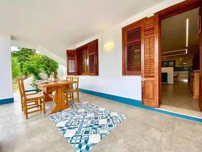 a kitchen and dining room with a table and chairs at Apartment Villa Sao- Scopello- Punta Pispisa by Interhome in Scopello