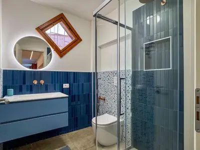 a bathroom with a toilet and a glass shower at Apartment Villa Sao- Scopello- Punta Pispisa by Interhome in Scopello