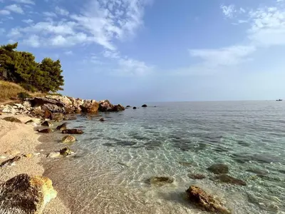 a beach with rocks and the clear water at Apartment Villa Sao- Scopello- Punta Pispisa by Interhome in Scopello