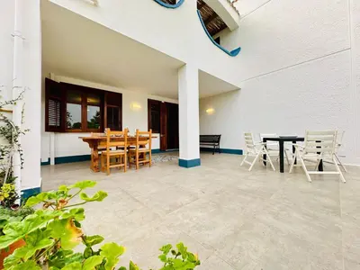a patio with a table and chairs in a house at Apartment Villa Sao- Scopello- Punta Pispisa by Interhome in Scopello
