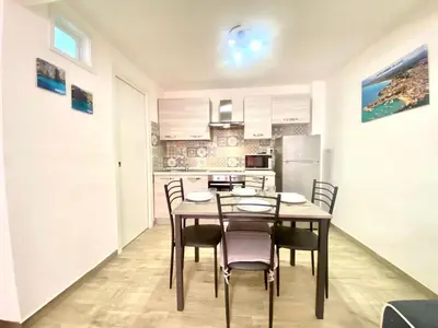 a dining room with a table and chairs in a kitchen at Apartment GS Urlaub del Golfo Haus mit Jacuzzi by Interhome in Castellammare del Golfo