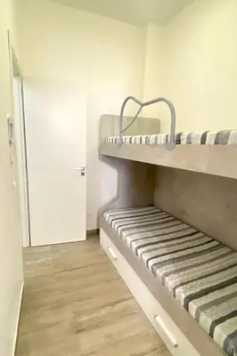 an empty bunk bed in a room with a door at Apartment GS Urlaub del Golfo Haus mit Jacuzzi by Interhome in Castellammare del Golfo