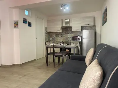 a living room with a couch and a kitchen at Apartment GS Urlaub del Golfo Haus mit Jacuzzi by Interhome in Castellammare del Golfo