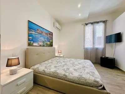 a bedroom with a large bed and a window at Apartment GS Urlaub del Golfo Haus mit Jacuzzi by Interhome in Castellammare del Golfo
