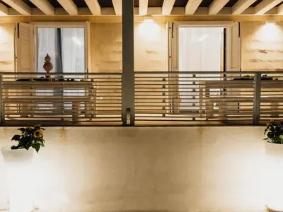 a balcony with benches and windows in a building at Holiday Home Haus in Balestrate mit privatem Parkplatz by Interhome in Balestrate