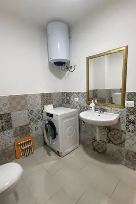 a bathroom with a washing machine and a sink at Apartment Wohnung maestrale Sizilien home by Interhome in Balestrate