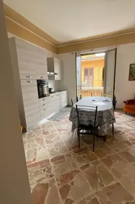 a living room with a table and a kitchen at Apartment Wohnung maestrale Sizilien home by Interhome in Balestrate
