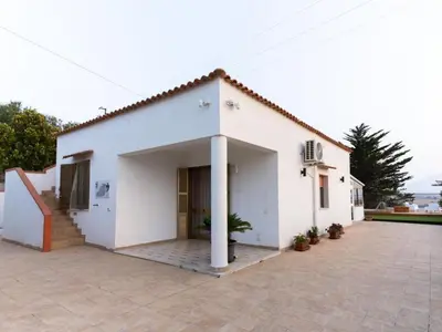 a white house with a courtyard in front of it at Holiday Home Villa Panorama del Golfo mit privatem Pool und Grillplatz by Interhome in Balestrate