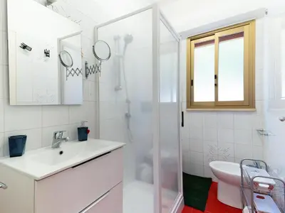 a white bathroom with a sink and a shower at Holiday Home Villa Panorama del Golfo mit privatem Pool und Grillplatz by Interhome in Balestrate