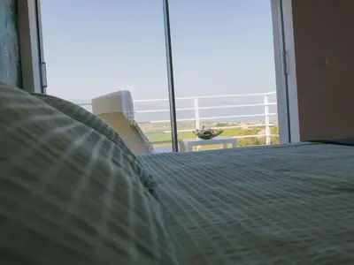 a bedroom with a bed and a large window at Holiday Home in Partinico mit Privatem Pool by Interhome in Balestrate
