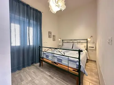 a bedroom with a bed and a window at Holiday Home Villa Oasi- 50 m vom Strand entfernt- klimatisiert by Interhome in Alcamo