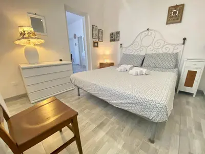 a bedroom with a bed with two towels on it at Holiday Home Villa Oasi- 50 m vom Strand entfernt- klimatisiert by Interhome in Alcamo