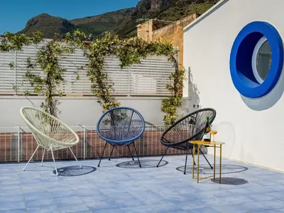 two chairs and a table on a patio at Apartment BluOltremare-Terrasse by Interhome in Castellammare del Golfo