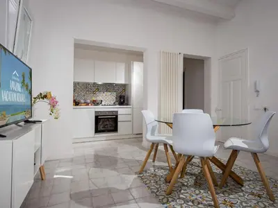 a living room with a glass table and white chairs at Apartment BluOltremare-Terrasse by Interhome in Castellammare del Golfo