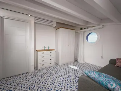 a room with a bed and a dresser and a bedroom at Apartment BluOltremare-Terrasse by Interhome in Castellammare del Golfo