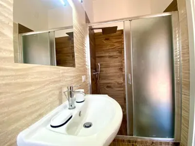 a bathroom with a white sink and a shower at Holiday Home Villa Grace- Strand 200 m entfernt by Interhome in Alcamo