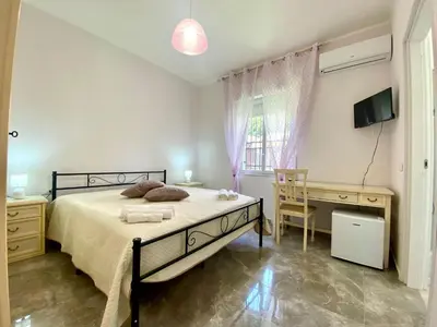 a bedroom with a bed and a desk and a television at Holiday Home Villa Grace- Strand 200 m entfernt by Interhome in Alcamo
