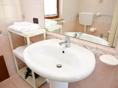 a bathroom with a white sink and a mirror at Holiday Home Villa mit Wasserblick by Interhome in Campofelice di Roccella
