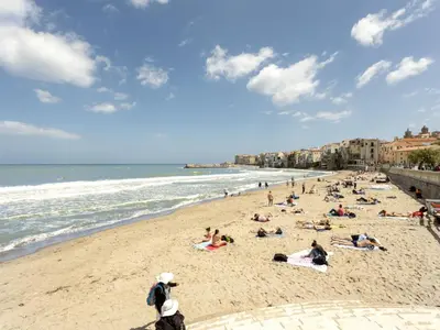 a group of people laying on the beach at Holiday Home Villa mit Wasserblick by Interhome in Campofelice di Roccella