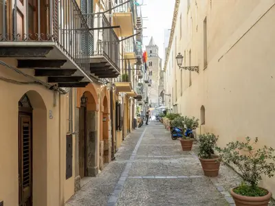 an alley in an old town with potted plants at Holiday Home Villa mit Wasserblick by Interhome in Campofelice di Roccella