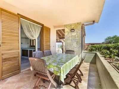 a patio with a table and chairs on a balcony at Holiday Home Ferienvilla mit Wasserblick by Interhome in Campofelice di Roccella