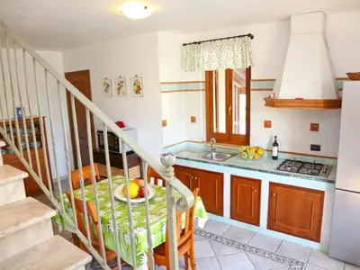 a kitchen with a staircase and a table and a sink at Holiday Home Ferienvilla mit Wasserblick by Interhome in Campofelice di Roccella