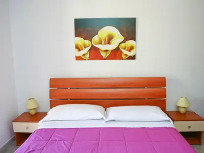 a bedroom with a bed with a purple blanket at Holiday Home Ferienvilla mit Wasserblick by Interhome in Campofelice di Roccella