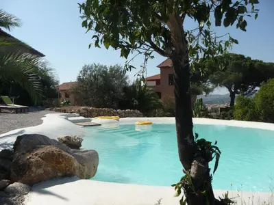 a swimming pool with a tree in the middle at Holiday Home Manderino-Panoramasuite mit Park und Pool by Interhome in Santa Flavia