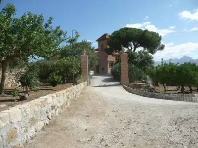 a stone path leading to a house with trees at Holiday Home Manderino-Panoramasuite mit Park und Pool by Interhome in Santa Flavia