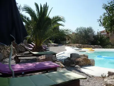 a swimming pool with chaise lounges and a resort at Holiday Home 'Suite Zibibbo' mit Aussicht by Interhome in Santa Flavia