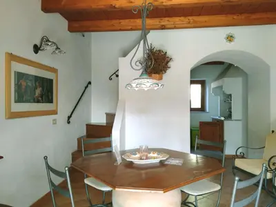 a dining room with a wooden table and chairs at Holiday Home 'Suite Zibibbo' mit Aussicht by Interhome in Santa Flavia