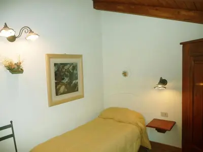 a bedroom with a bed and a picture on the wall at Holiday Home 'Suite Zibibbo' mit Aussicht by Interhome in Santa Flavia
