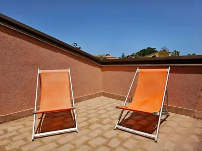 two orange chairs sitting on top of a building at Holiday Home Ferienvilla mit Wasserblick by Interhome in Campofelice di Roccella