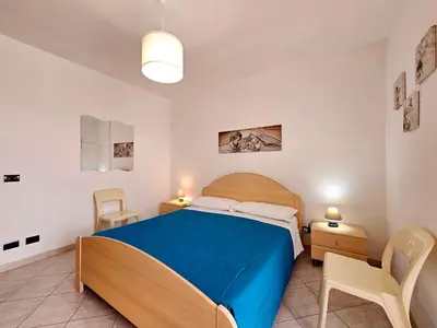 a bedroom with a bed and a table and chairs at Holiday Home Villa mit Wasserblick by Interhome in Campofelice di Roccella