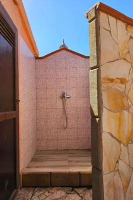 a bathroom with a shower in a brick wall at Holiday Home Villa mit Wasserblick by Interhome in Campofelice di Roccella