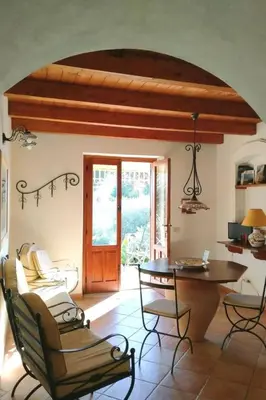 a room with a table and chairs and a door at Holiday Home 'Suite Ficodindia by Interhome in Santa Flavia
