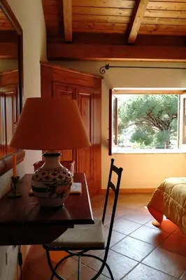 a lamp on a table in a room with a window at Holiday Home 'Suite Ficodindia by Interhome in Santa Flavia
