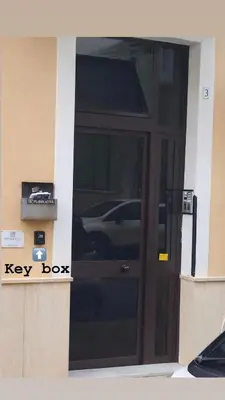 a door to a key box on the side of a building at VITALENTA Palermo apartment in Palermo