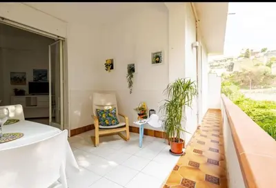 a room with a table and a chair on a balcony at Stella a 3 minuti dal mare e a 30 Min from San Vito in Alcamo Marina